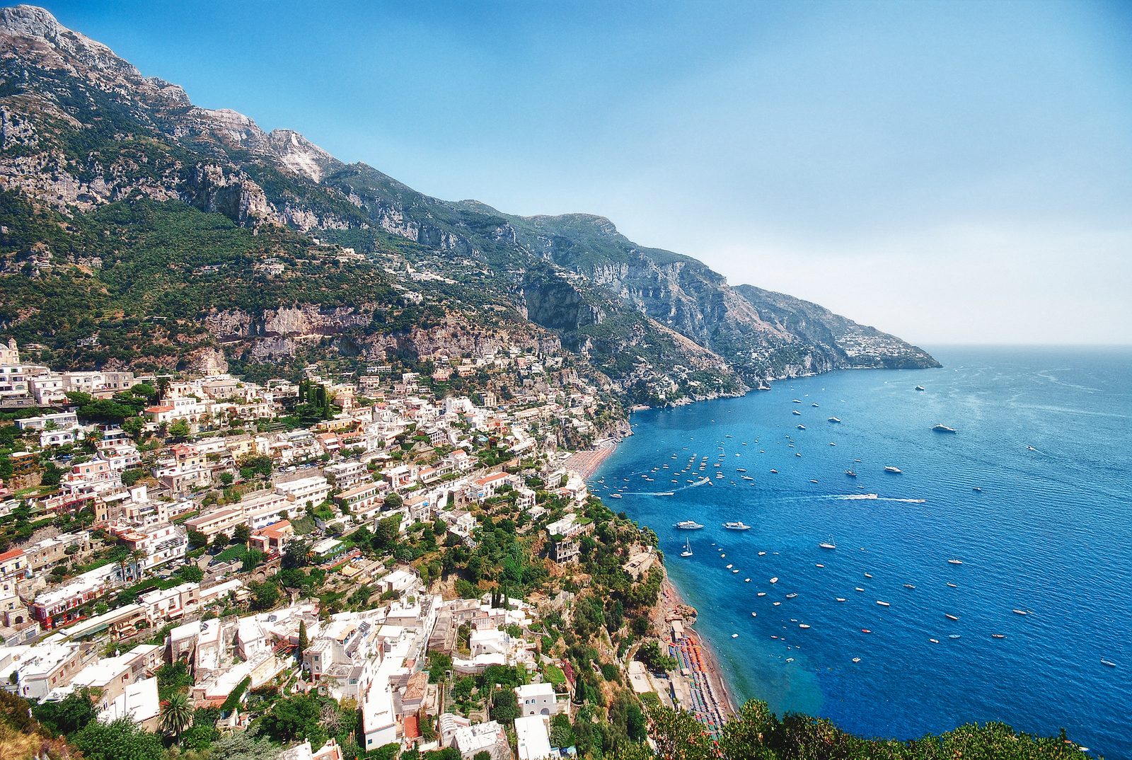 Aerial view of the Amalfi Coast, with whitewashed towns lining the cliffs above the Tyrrhenian Sea